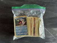 Front view of ziplock bag filled with Pokémon cards, Carvanha card visible