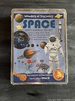 Front of sealed Wonders of Discovery Space Educational Tin Set showing title and contents