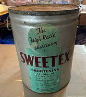 Front of Sweetex metal pail showing graphics, lid and handles