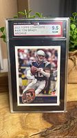 Front of graded Tom Brady card showing KSA 9.5 label and card image