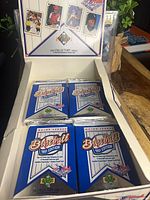 Open display box showing four sealed 1991 Upper Deck Baseball packs
