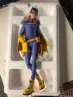 Batgirl statue in foam packaging showing full figure, costume colors, and condition