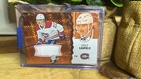 Front of Cole Caufield Upper Deck Ice jersey card in top loader