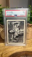 Front of PSA-slabbed 1990 Score Bo Jackson card showing black-and-white image and PSA label
