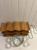 Overview showing wooden wine rack, crystal ice bucket, crystal glasses, chrome bottle holder