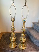 Front view of both brass table lamps standing upright