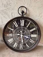 Front view showing dial, numerals, frame, and decorative gears