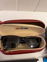 Colours by Alexander Julian rectangular sunglasses inside red Armani Jeans hard case