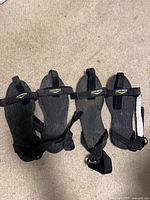 Top view of four ice cleats showing straps and branding