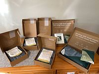 Five open Lomi boxes showing filter and activator pouches