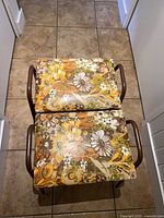 two floral vinyl stacking stools on brown tubular metal frames
