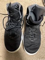 Pair of black Nike high-top basketball shoes front view