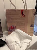 Tuscan’s Firenze dust bag and branded paper shopping bag visible