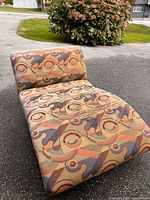 Top view showing abstract patterned upholstery and tears on seat area