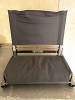 Front view of black folding stadium seat