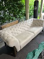 Full view of tufted grey sofa