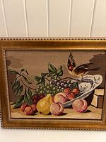 Full view of framed petit point still life tapestry