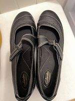 Top view black leather Clarks Mary Jane flats with strap