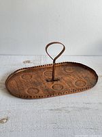 Top view of copper tray showing hammered circles and handle