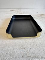 Tray front view showing black interior and brass sides