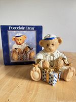 Front view of porcelain bear figurine with original box