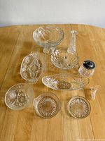 Group shot of all ten clear glass pieces on table