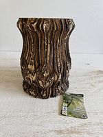 Front view of ridged ponga wood vase with tag