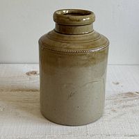 Front view of stoneware crock vase showing overall form and glaze