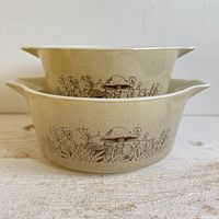 Two stacked Pyrex Forest Fancies bowls showing exterior pattern