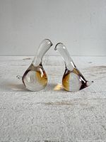 Front view of both glass bird figurines showing overall form and coloration
