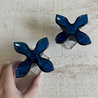 Top view showing X-shaped cobalt blue candlestick holders with clear bases