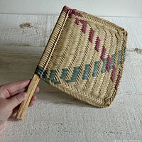 Front view of woven fan showing full pattern and handle