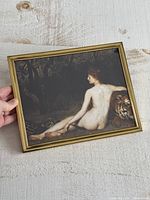 Front view showing entire framed artwork, hand for scale