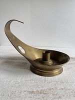Side view showing brass holder, looped handle, candle socket and patina