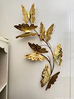 Full view of welded metal butterfly wall sculpture on wall