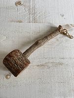 Full view of wooden novelty hammer showing handle, head and hanging loop