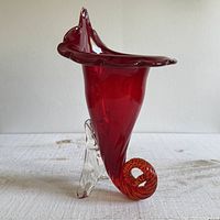 Front angled view showing red body, clear support, spiral base