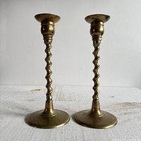 Full view of both brass candlestick holders front