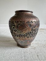 Full view of vase front showing etched deer scene and patina