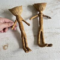 Two woven raffia dolls front view