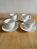All four cup and saucer sets on table