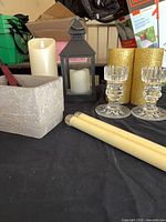 Group shot showing all candles, candlesticks, lantern, textured holder