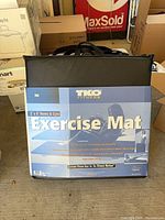 Front view of boxed TKO Fitness exercise mat showing branding and size