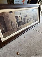 Full view of framed panoramic canvas on floor