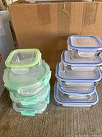 Stack of five mint green-lidded containers alongside stack of five blue-lidded containers