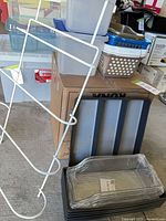 group shot of totes, baskets, drawer dividers stack, towel rack leaning against box