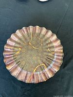 Top view showing ruffled edge and gold swirl pattern on one plate