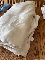 Folded cream plush blanket on table