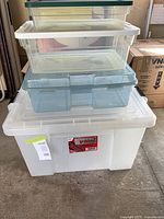 Stacked view of all four plastic totes showing sizes and lids