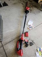 Full view of Craftsman pole hedge trimmer with battery, charger, earplugs and manual